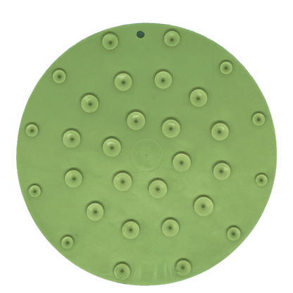 Green dog lick mat with suction cups on a white background