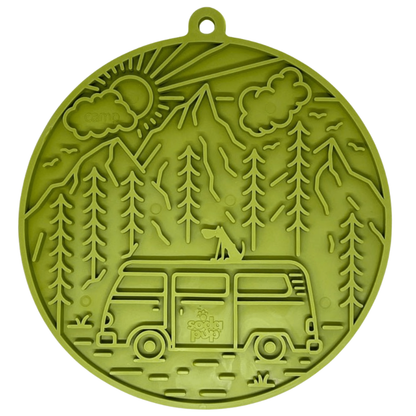 Green silicone dog lick mat with camping design featuring a van and trees on a white background