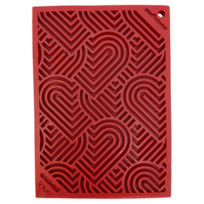 Red textured dog lick mat mat with heart pattern on a white background