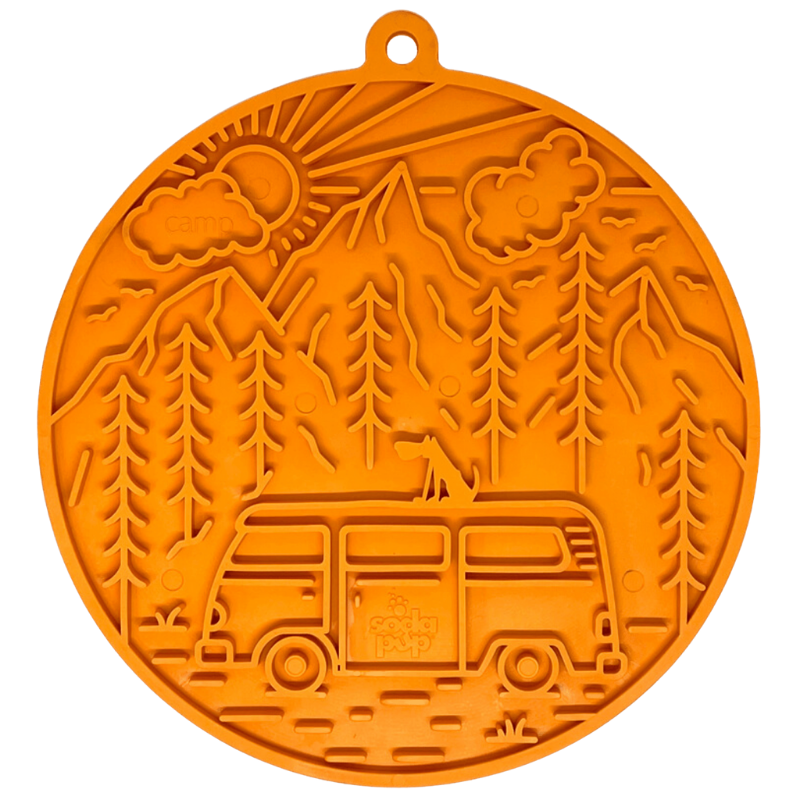 Orange silicone dog lick mat with a design of a van, trees, and mountains on a white background