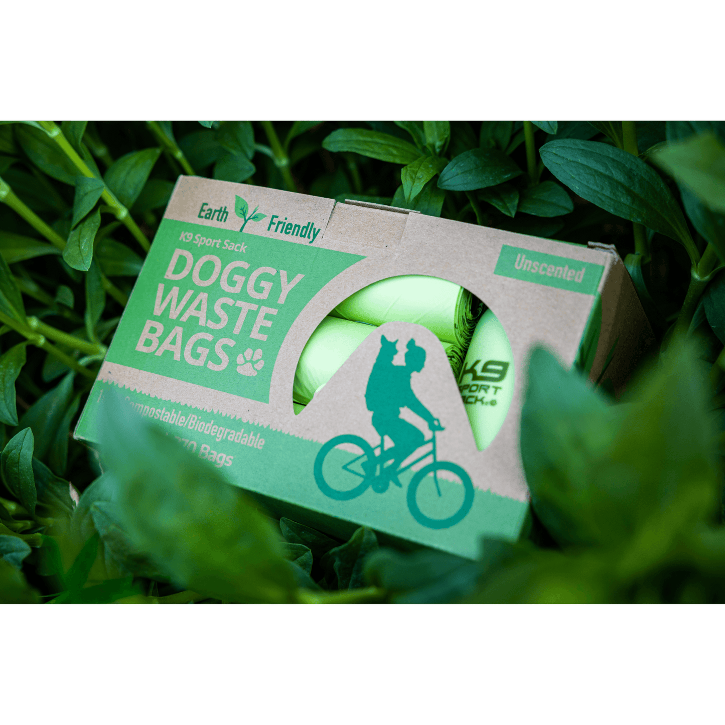 Box of doggy waste bags with a green label on grass