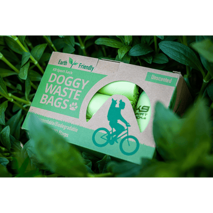 Box of doggy waste bags with a green label on grass