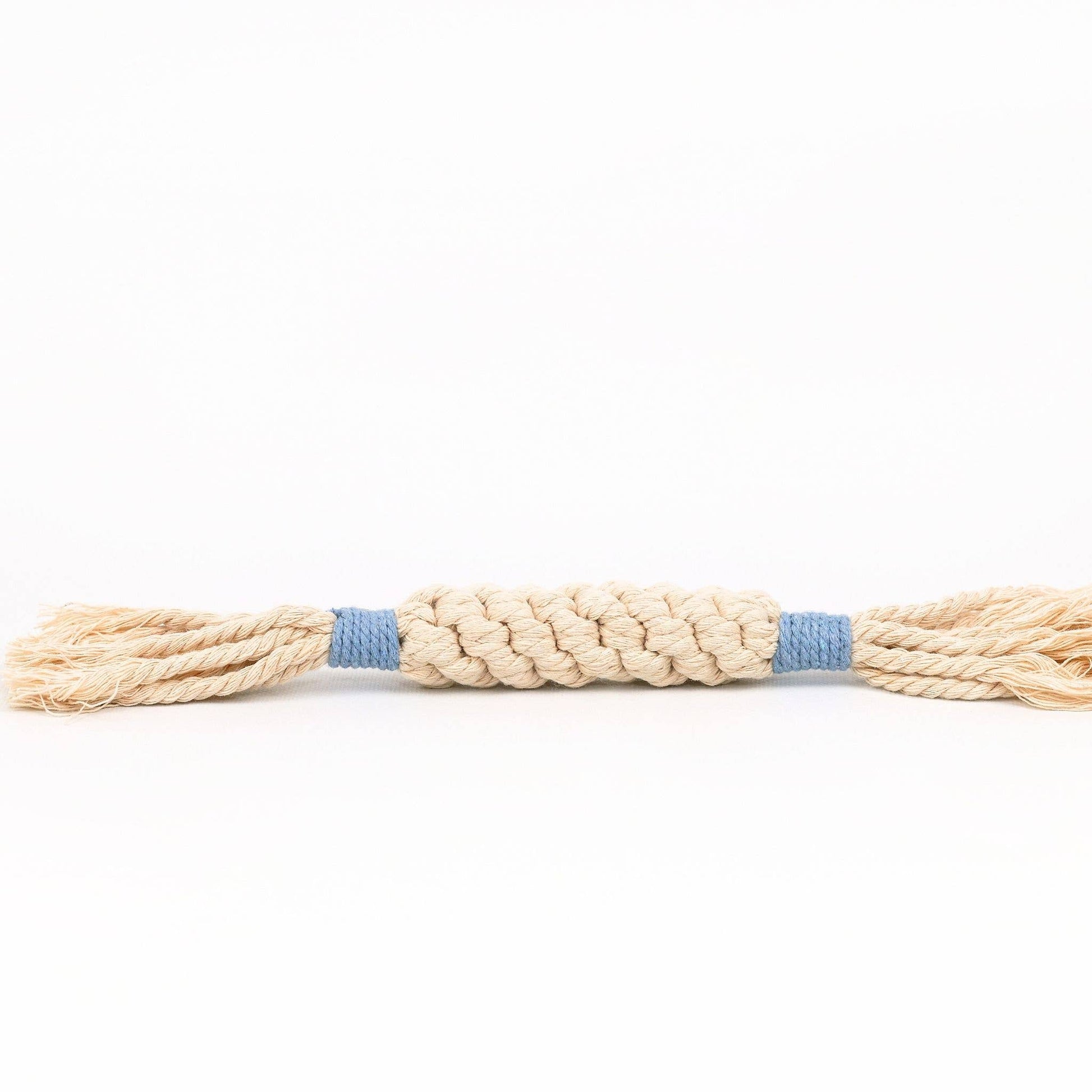 Beige rope dog toy with a blue center on a white background