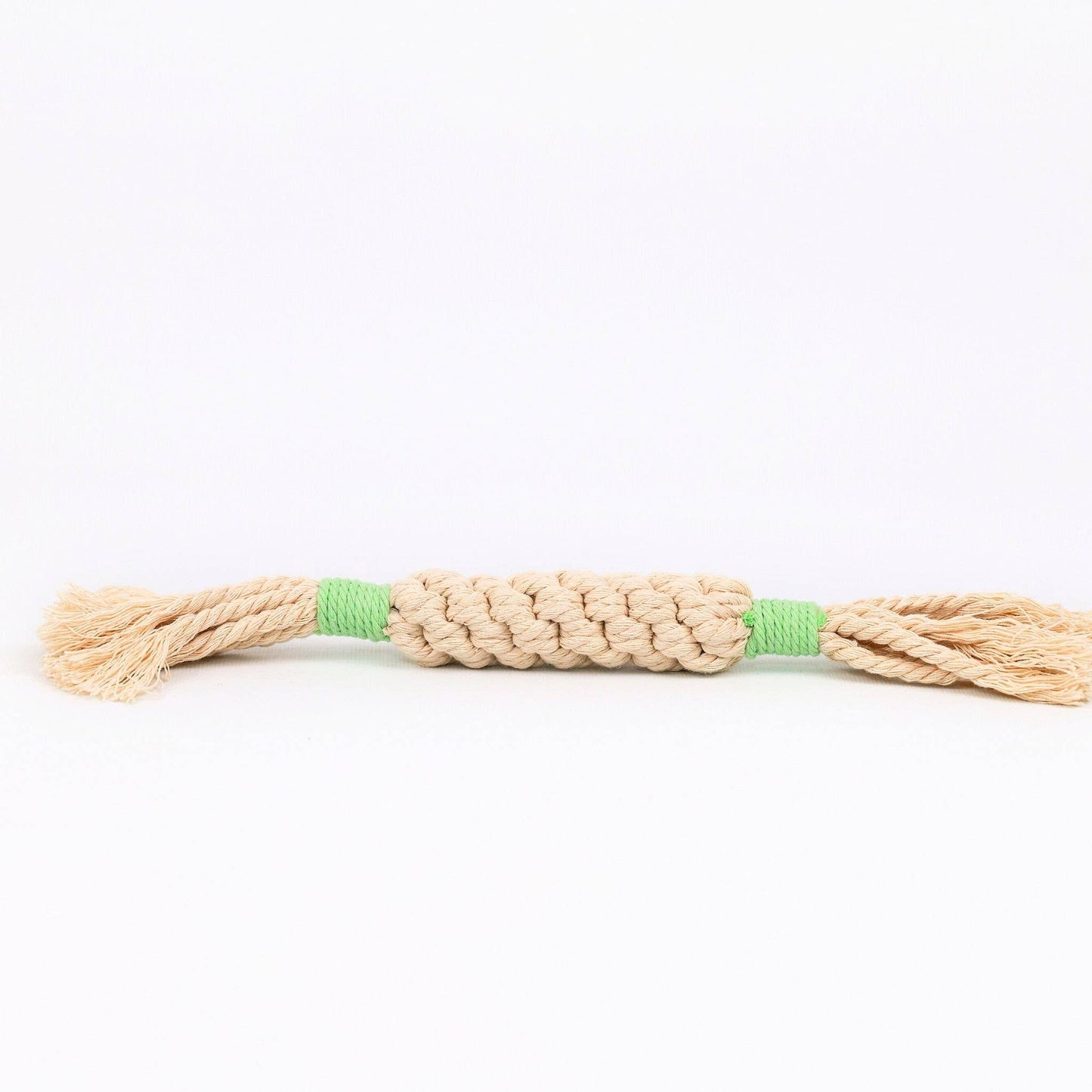 Beige dog toy rope with green accents on a white background