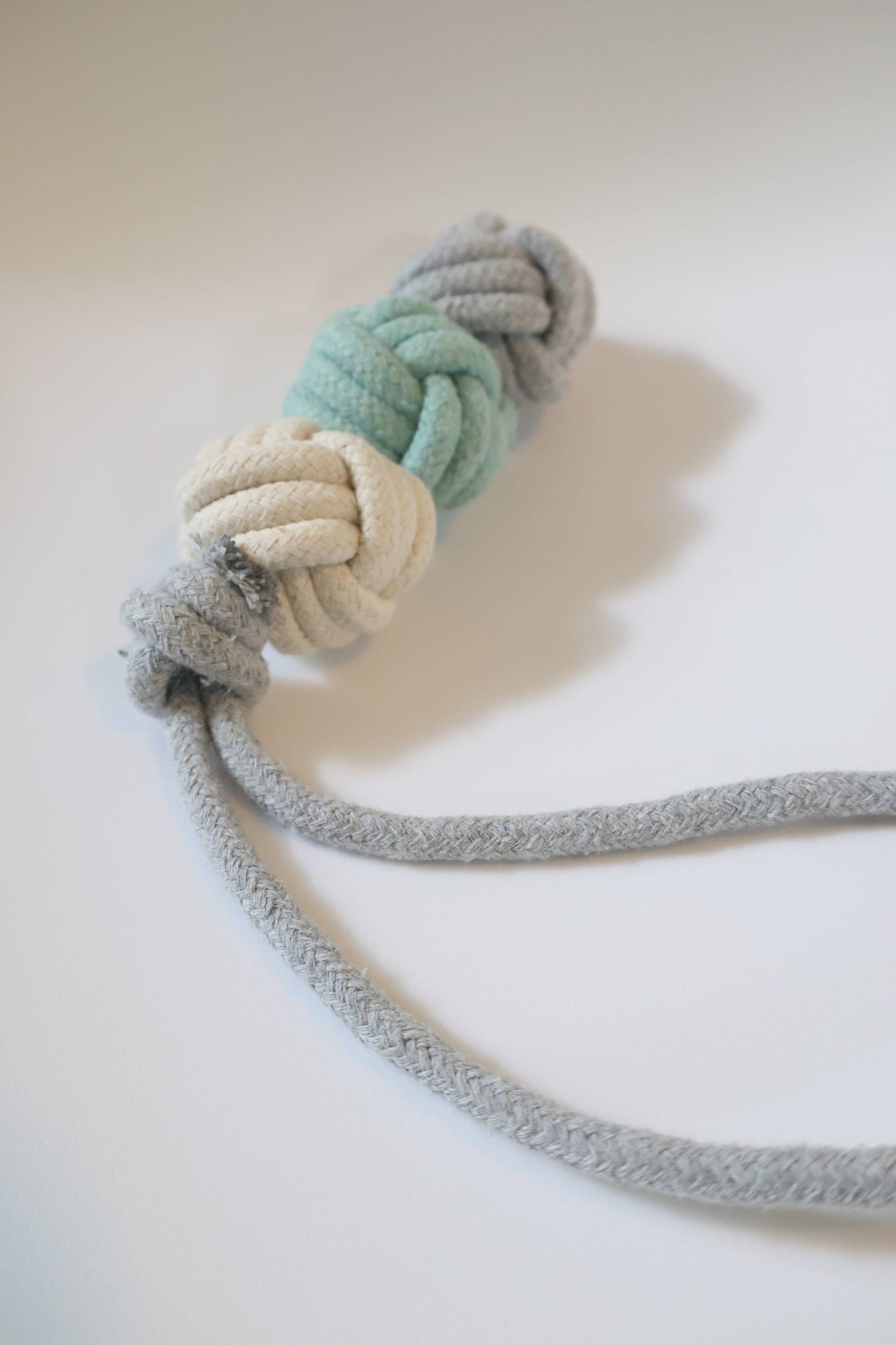 Rope toy with a knot on a light background