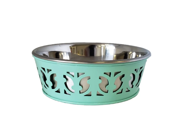 Mint green pet bowl with decorative cutout design on a white background
