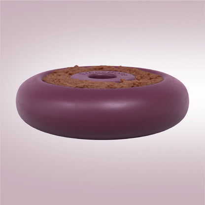 Round purple object with cork-like texture on a light pink background