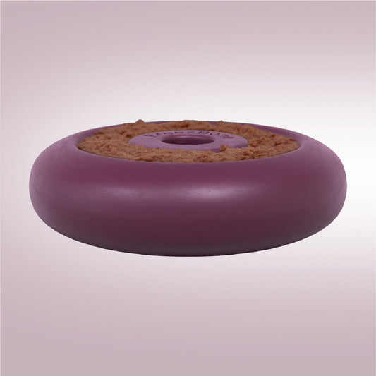 Round purple object with cork-like texture on a light pink background