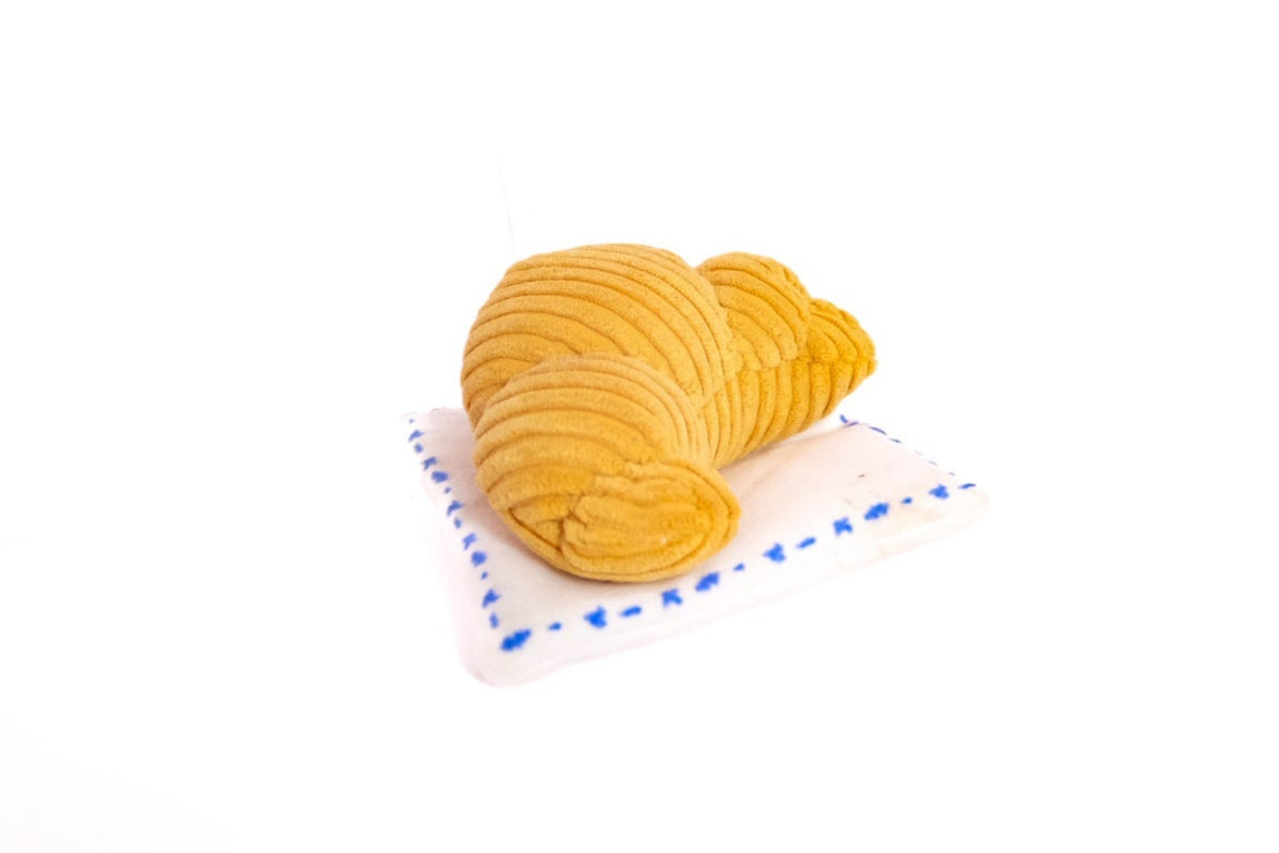Golden brown croissants on a white surface with a blue border