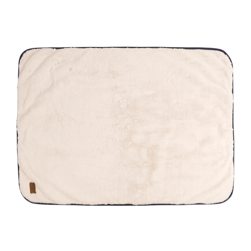 Beige blanket with a brown label on a white background