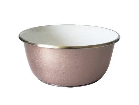 Rose gold dog bowl with white interior on a white background