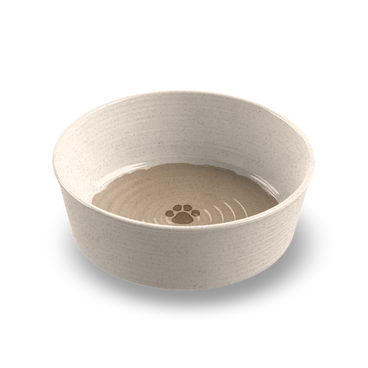 Beige pet bowl with paw print design on a white background