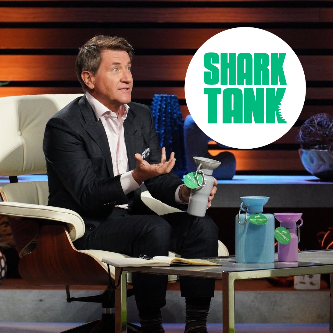 Person on a Shark Tank set with product display