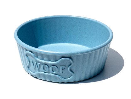 Blue pet bowl with 'WOOF' engraving on a white background