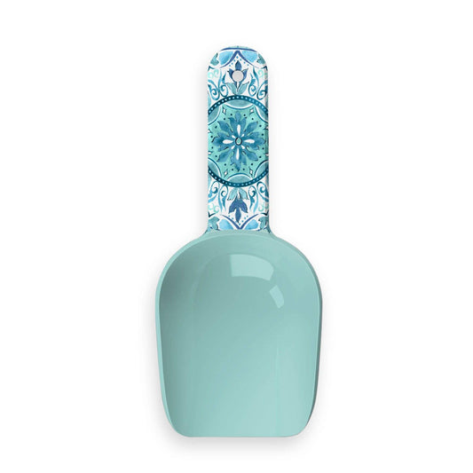 Teal scoop with decorative handle on a white background