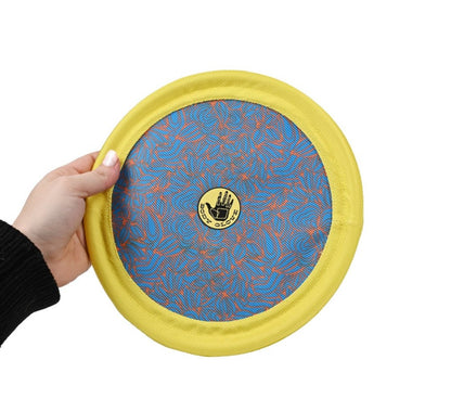 Hand holding a yellow frisbee with a blue center and visible brand logo on a white background