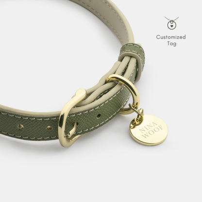 Green dog collar with gold hardware and a personalized tag on a white background