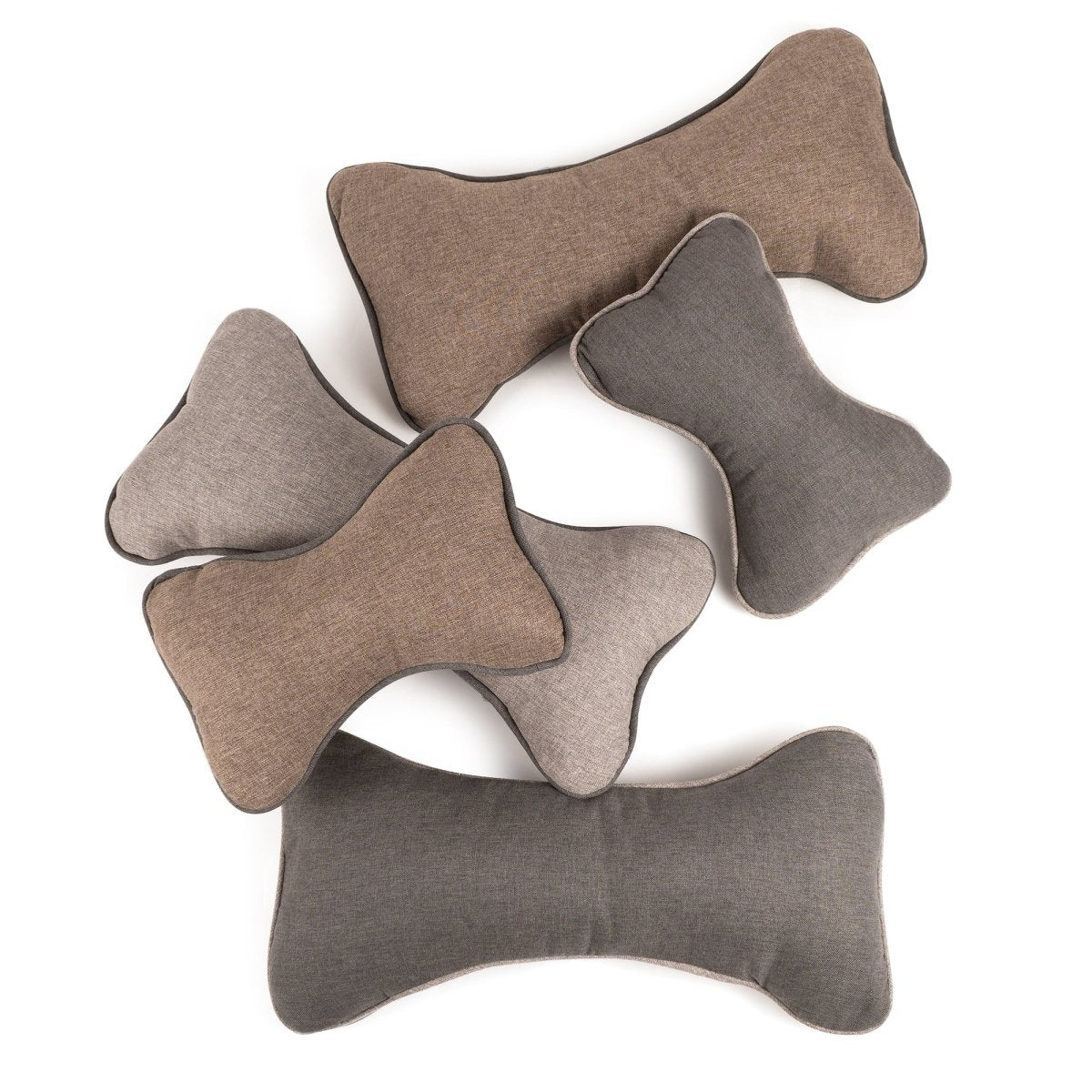 Set of bone-shaped cushions in various shades of gray and brown on a white background