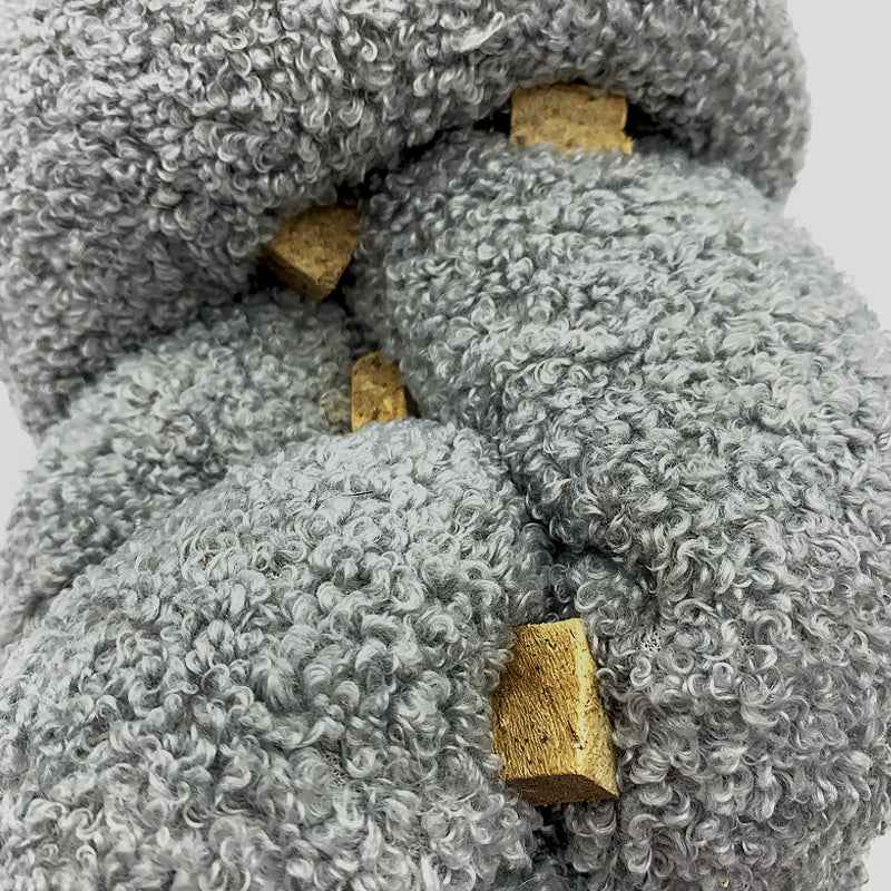 Super Knott gray knotted dog toy on a white background with dog treats tucked into it