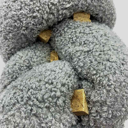 Super Knott gray knotted dog toy on a white background with dog treats tucked into it