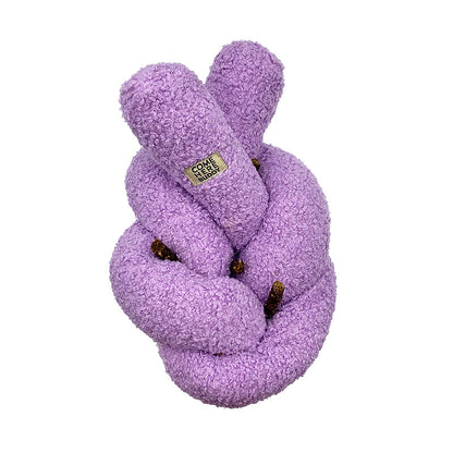 Super Knott purple knotted dog toy on a white background with dog treats tucked into it