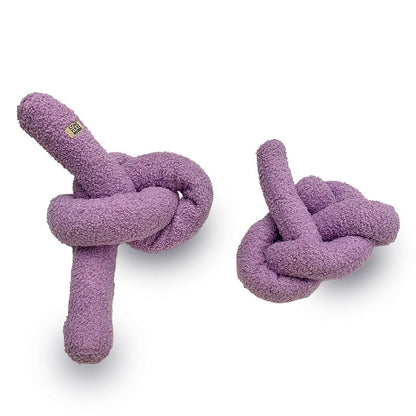 Two purple knotted dog toys on a white background