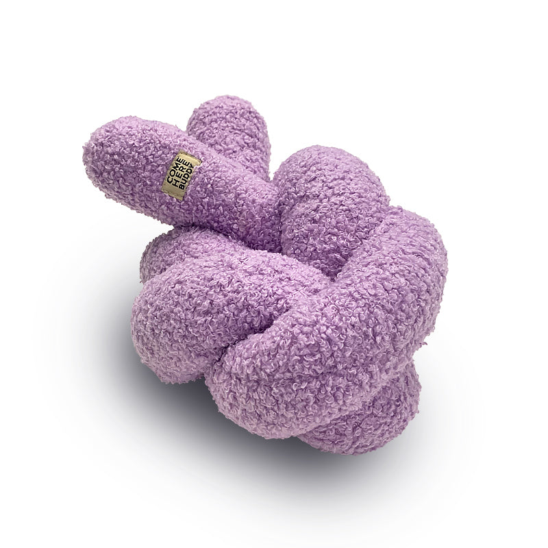 Purple knitted dog toy on a white background