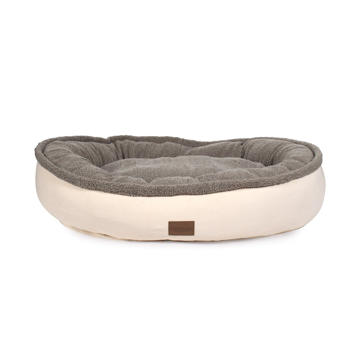 Dog bed with gray cushion and beige base on a white background