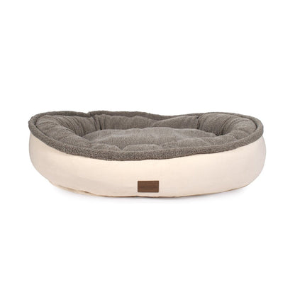 Dog bed with gray cushion and beige base on a white background