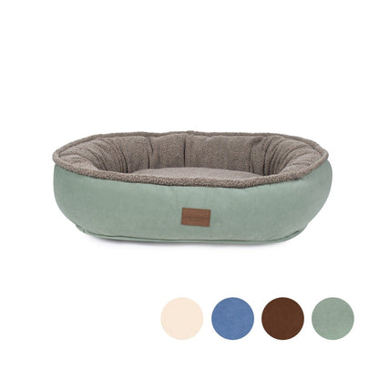 Pet bed with brown interior and green exterior on a white background