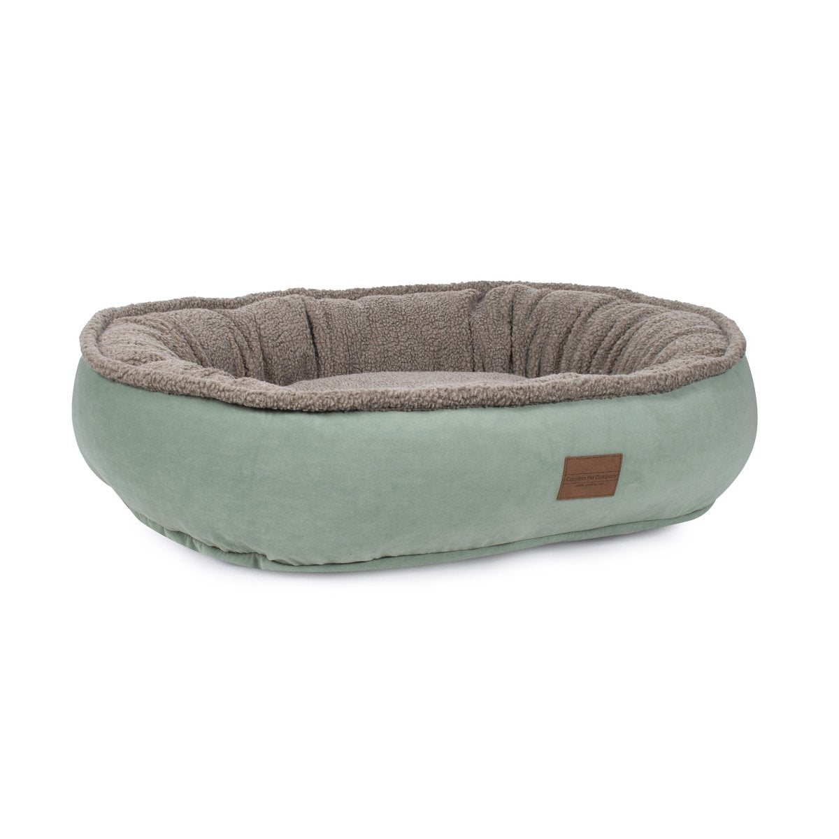 Pet bed with brown interior and green exterior on a white background