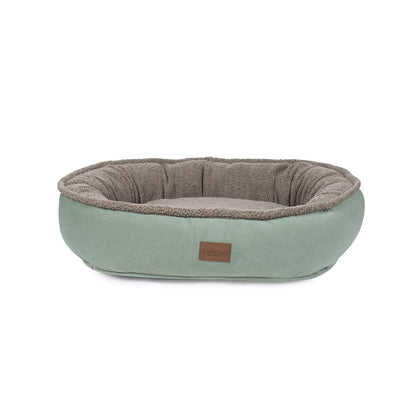 Pet bed with a brown interior and light green exterior on a white background