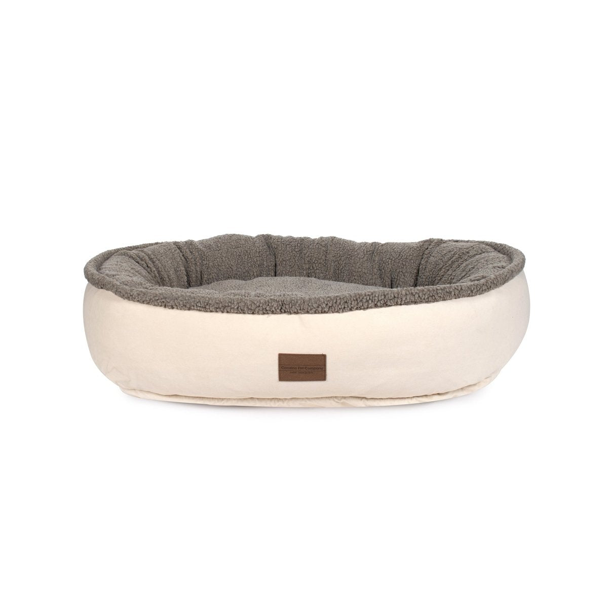 Pet bed with gray interior and beige exterior on a white background