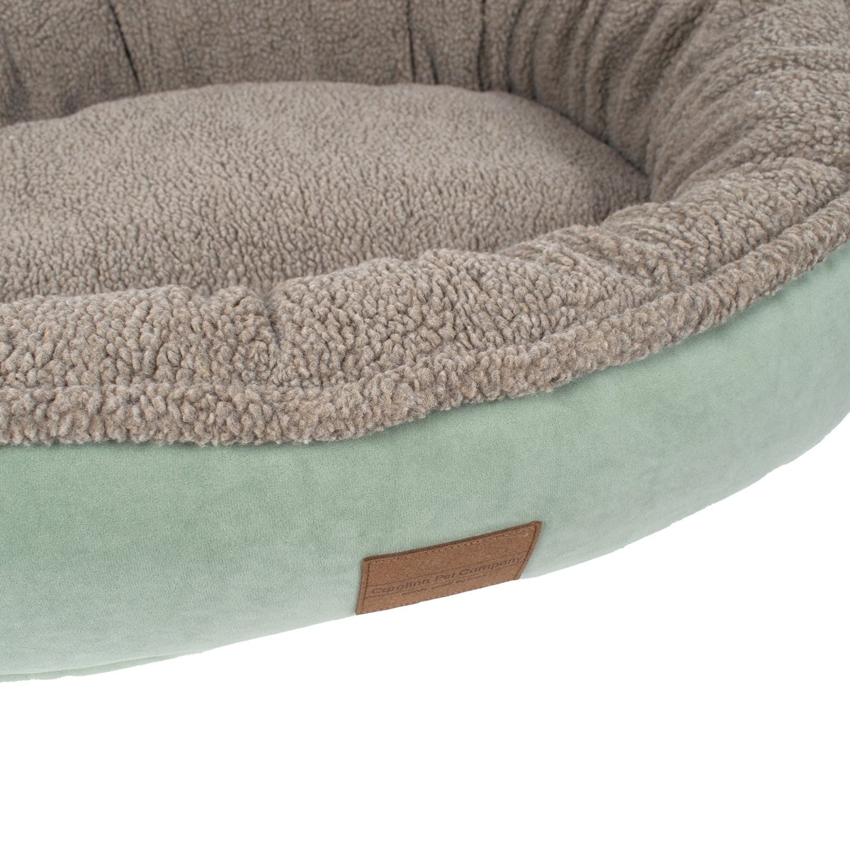 Pet bed with a soft texture and a visible brand label on a white background