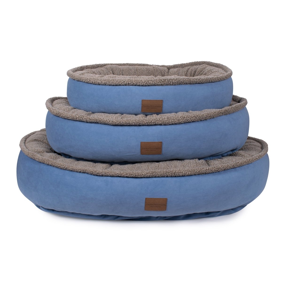 Set of three blue pet beds with brown labels on a white background