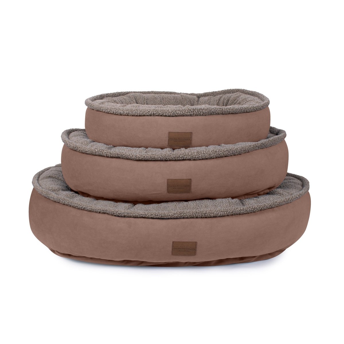 Three brown pet beds of different sizes on a white background