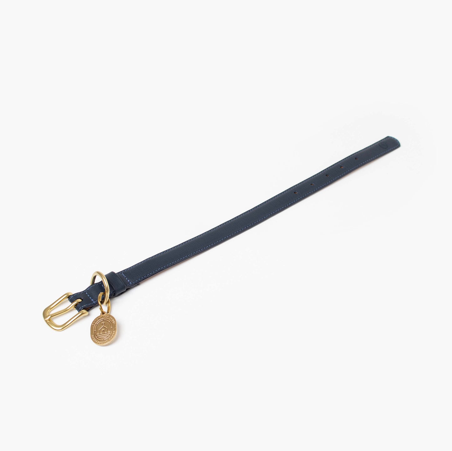 Navy collar with gold buckle and tag on a white background