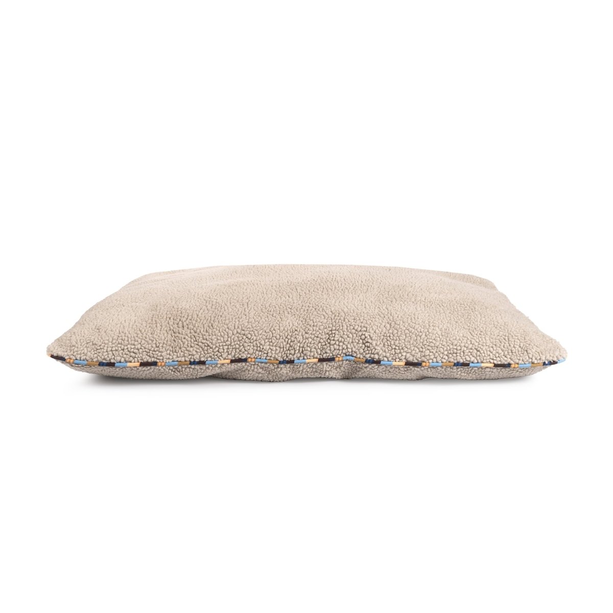 Beige pillow with a textured edge on a white background