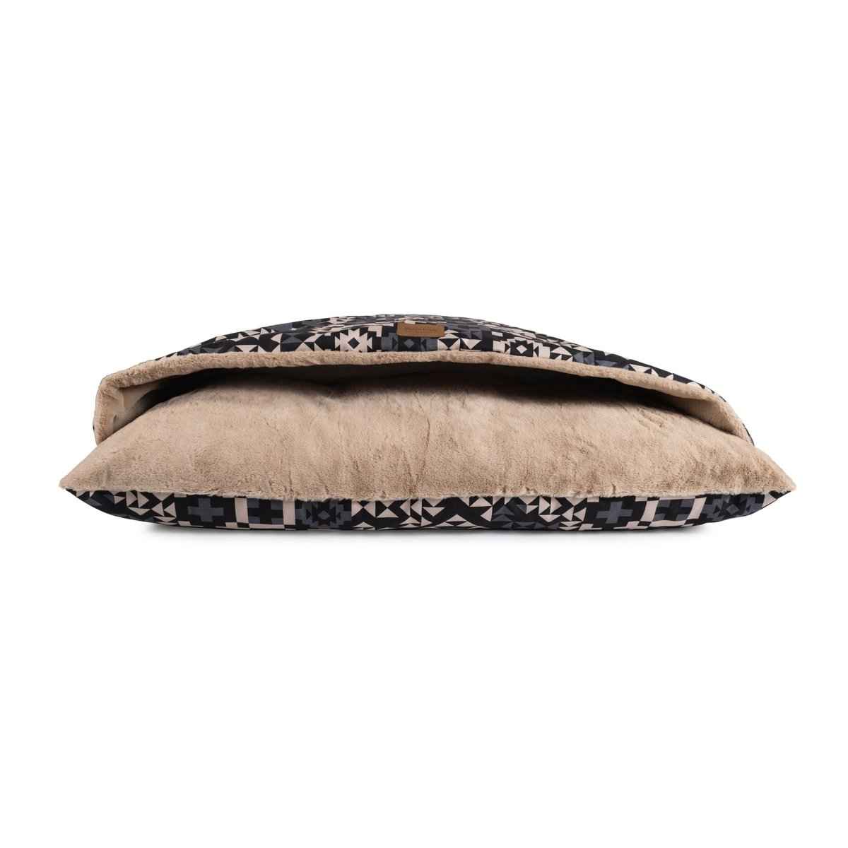 Pendleton Burrow Bed in blue and black design with tan interior on white background