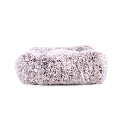 Fluffy white pet bed on a white background