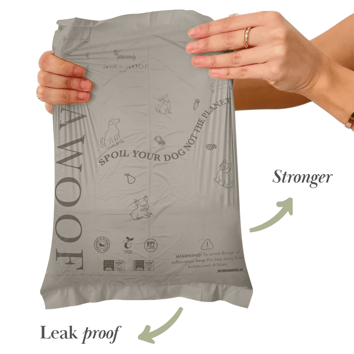 Hand holding a gray dog waste bag package with text and icons on a white background